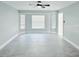 Bright living room with large windows, tile flooring, and a ceiling fan at 1178 Sultana St, Port Charlotte, FL 33952