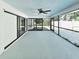 This screened patio features concrete flooring, a ceiling fan, and sliding glass doors to the exterior at 1178 Sultana St, Port Charlotte, FL 33952