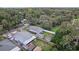 Aerial view shows fenced yard, utility building, mature trees, and community park access at 1206 E Frierson Ave # B, Tampa, FL 33603