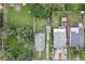 Aerial view of the property featuring a spacious yard, shed, driveway, and the home's layout at 1206 E Frierson Ave # B, Tampa, FL 33603
