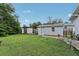 Spacious backyard with green grass, shed, and gate leading to a patio area, perfect for outdoor enjoyment at 1206 E Frierson Ave # B, Tampa, FL 33603