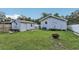 Spacious backyard featuring lush green grass, a shed, and a charming fire pit, perfect for outdoor gatherings at 1206 E Frierson Ave # B, Tampa, FL 33603