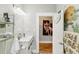 Stylish bathroom featuring a modern vanity, decorative mirror, and unique black and white patterned floor tiles at 1206 E Frierson Ave # B, Tampa, FL 33603