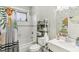 Updated bathroom features a tub, shower, decorative curtain, and stylish storage solutions at 1206 E Frierson Ave # B, Tampa, FL 33603