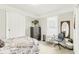Cozy bedroom with neutral tones, complemented by natural light and a decorative dresser and mirror at 1206 E Frierson Ave # B, Tampa, FL 33603