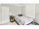 Comfortable bedroom featuring light-colored walls, a floral patterned bedspread, and soft natural light at 1206 E Frierson Ave # B, Tampa, FL 33603
