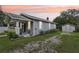 Charming home featuring a cozy front porch, complemented by lush greenery and a detached garage at 1206 E Frierson Ave # B, Tampa, FL 33603
