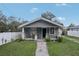 Charming home with a welcoming front porch, lovely landscaping, and a well-maintained lawn at 1206 E Frierson Ave # B, Tampa, FL 33603
