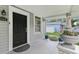 Cozy front porch with a black door, planters, and a welcome mat at 1206 E Frierson Ave # B, Tampa, FL 33603