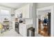 Modern kitchen with white cabinets, stainless steel appliances, and marble-patterned flooring at 1206 E Frierson Ave # B, Tampa, FL 33603