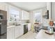 Bright kitchen features white cabinetry, stainless steel appliances, and patterned window at 1206 E Frierson Ave # B, Tampa, FL 33603