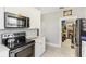 Kitchen with stainless steel appliances, white cabinets, and marble-look tile flooring at 1206 E Frierson Ave # B, Tampa, FL 33603