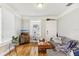 Inviting living room with hardwood floors, a gray sofa, and a stylish media cabinet at 1206 E Frierson Ave # B, Tampa, FL 33603