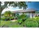 Backyard featuring mature landscaping, a patio seating area, and a view of the home at 1210 Wolford Dr, Trinity, FL 34655