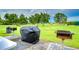 Community barbecue area with grills on manicured lawn, inviting outdoor gatherings and picnics at 1210 Wolford Dr, Trinity, FL 34655