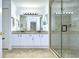 Bathroom with a double vanity, granite countertops, neutral tile flooring, and a glass-enclosed shower at 1210 Wolford Dr, Trinity, FL 34655