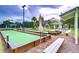Community bocce ball court, complete with benches and umbrellas, surrounded by lush landscaping at 1210 Wolford Dr, Trinity, FL 34655