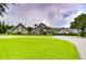 Expansive clubhouse with meticulous landscaping, circular driveway, and lush green lawns at 1210 Wolford Dr, Trinity, FL 34655