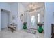 Elegant foyer showcasing a stylish chandelier, decorative mirror, tiled floor, and an ornate bench at 1210 Wolford Dr, Trinity, FL 34655