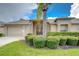Charming single-story home featuring a well-manicured lawn, mature landscaping, and a neutral color palette at 1210 Wolford Dr, Trinity, FL 34655