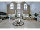 Elegant lobby area featuring high ceilings, marble floors, ample seating, and abundant natural light at 1210 Wolford Dr, Trinity, FL 34655