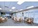 Spacious recreation room with tables, seating and lots of natural light shining through the louvered windows at 1210 Wolford Dr, Trinity, FL 34655
