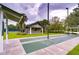 A community shuffleboard court with a clubhouse on a manicured lawn, perfect for outdoor recreation at 1210 Wolford Dr, Trinity, FL 34655