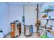 Bright utility room featuring two kilns, shelving, and wood-look flooring, perfect for artistic endeavors at 1210 Wolford Dr, Trinity, FL 34655
