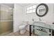 Stylish bathroom features a modern vanity with vessel sink and a glass-enclosed shower at 12222 Meadowbrook Ln, Hudson, FL 34667