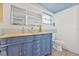 Charming bathroom features an ornate blue vanity and modern fixtures at 12222 Meadowbrook Ln, Hudson, FL 34667