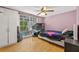 Bedroom with a window view of the backyard pool and a ceiling fan at 12222 Meadowbrook Ln, Hudson, FL 34667