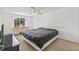 Bright bedroom has a large window and neutral carpet flooring at 12222 Meadowbrook Ln, Hudson, FL 34667