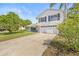 Attractive two-story home with a spacious driveway, lush lawn, and well-maintained landscaping at 12222 Meadowbrook Ln, Hudson, FL 34667