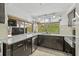 Kitchen features granite countertops, stainless appliances and backyard view at 12222 Meadowbrook Ln, Hudson, FL 34667