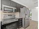 Kitchen area with stainless steel appliances and tile backsplash at 12222 Meadowbrook Ln, Hudson, FL 34667