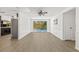 Open living area with wood floors, pool view and access at 12222 Meadowbrook Ln, Hudson, FL 34667