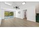 View of living area with wood floors, pool view, and staircase at 12222 Meadowbrook Ln, Hudson, FL 34667
