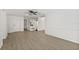 Spacious living area with wood floors and view of dining room at 12222 Meadowbrook Ln, Hudson, FL 34667