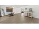 Well-lit living room featuring wood flooring, a media center, and ample space for furniture at 12222 Meadowbrook Ln, Hudson, FL 34667