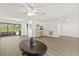 Inviting living room with wood-look flooring, neutral decor, and a view to the screened in porch at 12222 Meadowbrook Ln, Hudson, FL 34667