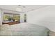 Comfortable main bedroom provides patio access and space for a home office at 12222 Meadowbrook Ln, Hudson, FL 34667