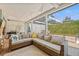 Enclosed patio features an outdoor seating area with comfortable wicker furniture and turtle themed decor at 12222 Meadowbrook Ln, Hudson, FL 34667