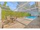 Outdoor pool area features comfortable patio furniture and privacy landscaping at 12222 Meadowbrook Ln, Hudson, FL 34667