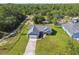 Aerial view of home showcasing the roof, driveway, and landscaping at 13227 Quigley Ave, Weeki Wachee, FL 34614