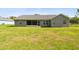 View of the house from the backyard showing a covered patio at 13227 Quigley Ave, Weeki Wachee, FL 34614