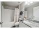 Bathroom featuring a combination tub and shower with gray vanity and granite countertops at 13227 Quigley Ave, Weeki Wachee, FL 34614