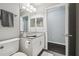 Bathroom featuring a single sink, granite countertops, white cabinets, and wood-look tile flooring at 13227 Quigley Ave, Weeki Wachee, FL 34614