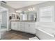 Bathroom boasting double sinks, granite countertops, and soaking tub at 13227 Quigley Ave, Weeki Wachee, FL 34614