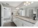 Bright bathroom featuring double sinks, granite countertops, modern lighting, and neutral tones at 13227 Quigley Ave, Weeki Wachee, FL 34614