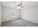 Neutral bedroom with gray carpet, a ceiling fan, and a window with blinds at 13227 Quigley Ave, Weeki Wachee, FL 34614
